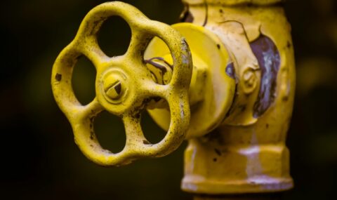 Industrial valve with yellow handwheel used for flow control in pipelines