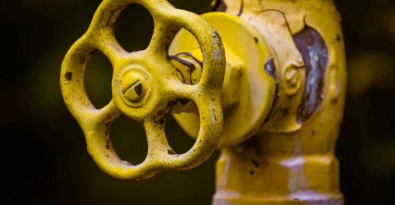 Industrial valve with yellow handwheel used for flow control in pipelines